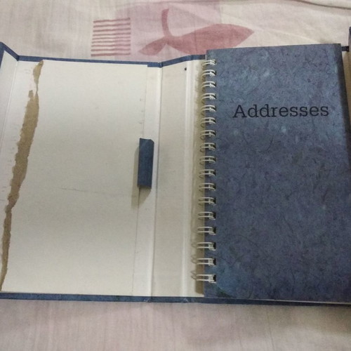 Phone book with magnetic closure and pen holder