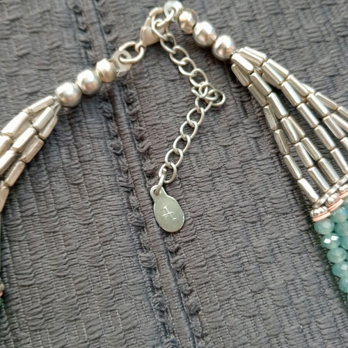 Accessorize multistrand necklace with plastic and glass beads