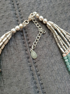 Accessorize multistrand necklace with plastic and glass beads