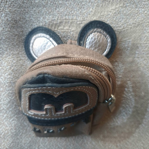 Coin purse used in mini backpack shape with decorative ears and letter M