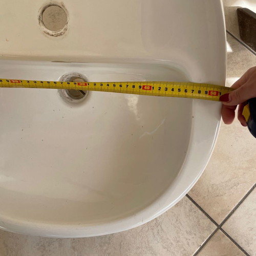 White bathroom sink used with minor small marks