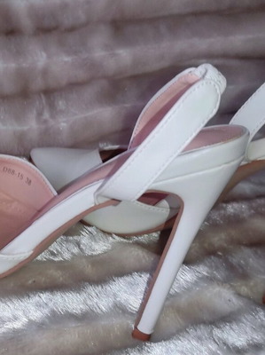 White pointed-toe pumps with stiletto heels... brand new!