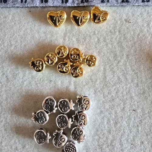Metal motifs like new shaped as pomegranate and heart in silver and gold