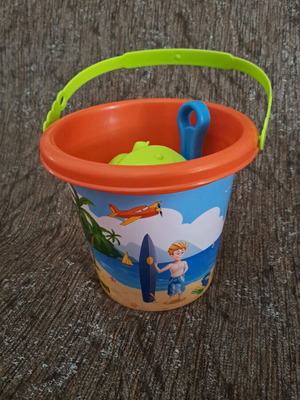 Beach bucket used with shovel and sand accessories