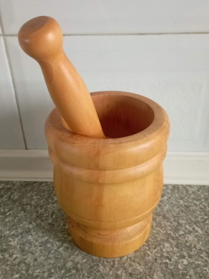 Wooden mortar used with crack at the base