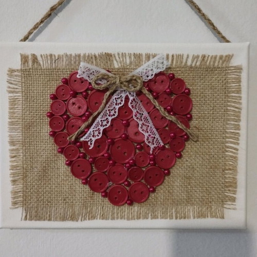 Handmade frame new with heart of buttons on canvas