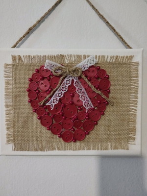 Handmade frame new with heart of buttons on canvas