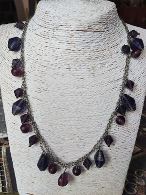 Necklace with purple beads on silver chain used