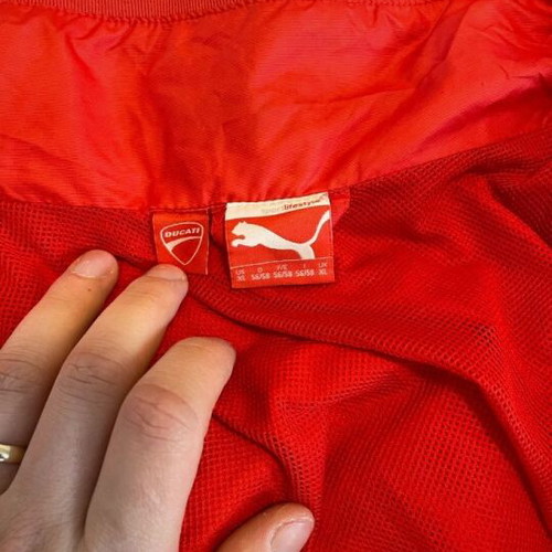 Ducati team jacket used, moderate condition with holes and stains
