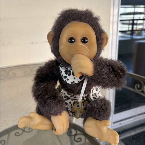 Vintage plush monkey toy with sound and hanging feature