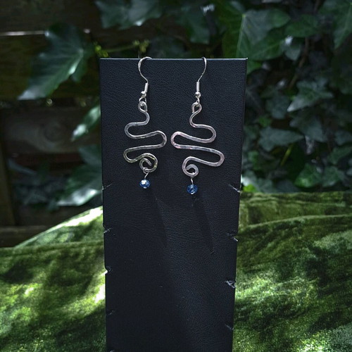 Swirly silver earrings with light blue crystal new