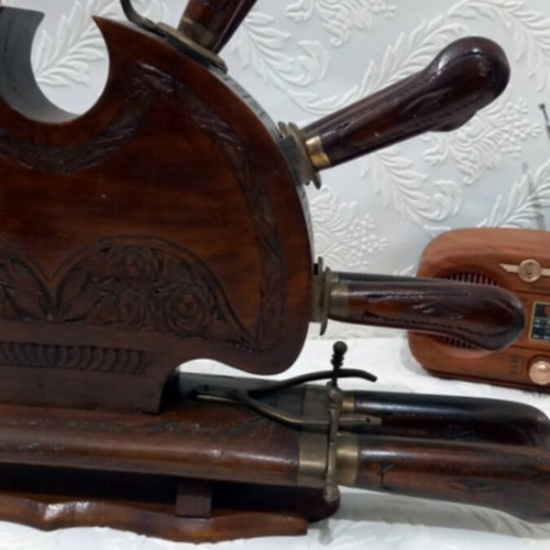 Wooden carved stand with used set of knives and forks