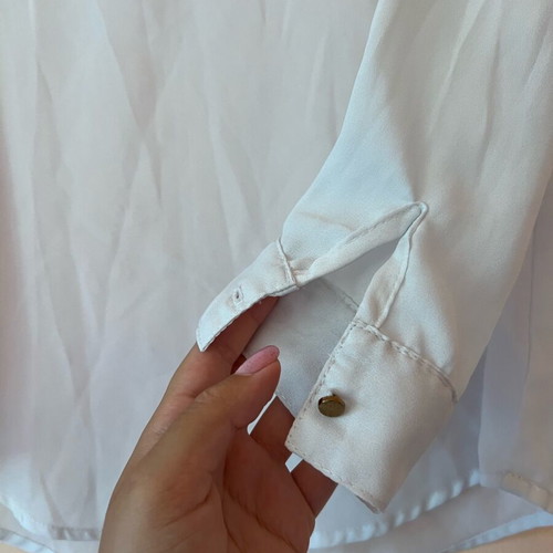 White blouse with silver details around neckline size M like new