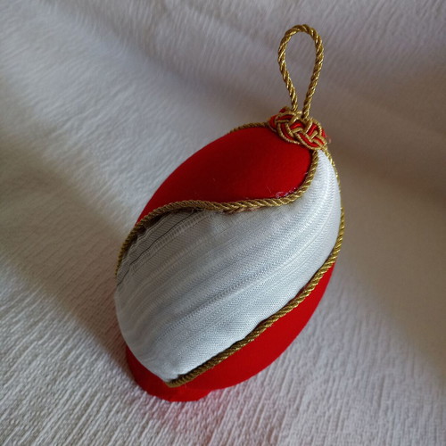 Decorative egg with spiral design used, red and gold