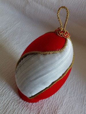 Decorative egg with spiral design used, red and gold