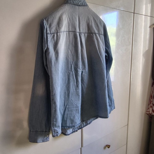 Light blue women's denim shirt with subtle polka dots