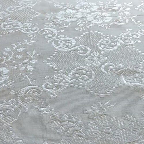 Woven quilt or throw with floral motifs, white