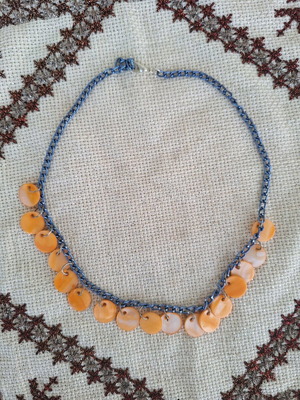Necklace with blue chain and orange mother of pearl elements made to order