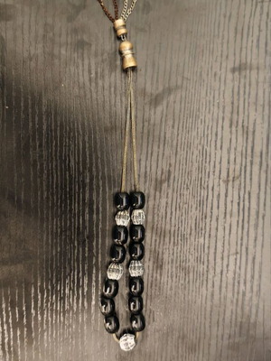 Black worry beads used with metal chain and details