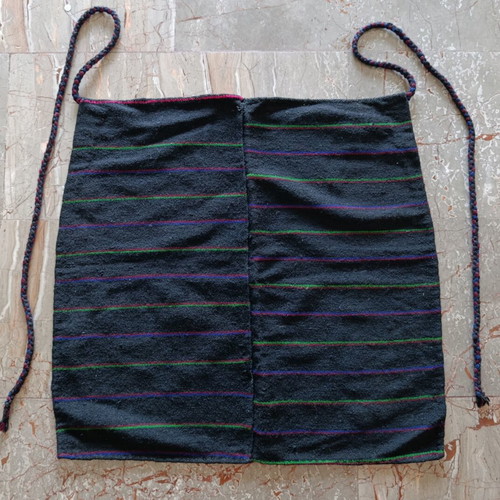 Traditional black apron with horizontal stripes used