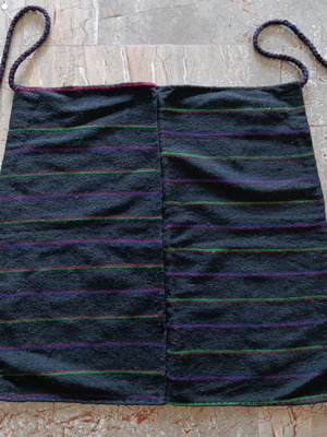 Traditional black apron with horizontal stripes used