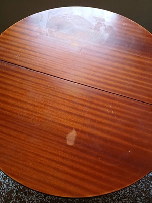 Round table with red tablecloth used, vintage wood design