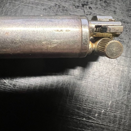 Silver lighter used, unknown if working