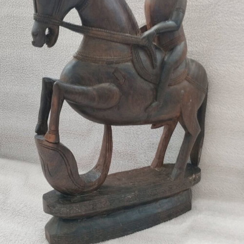 Wooden carving of South Indian man riding horse used
