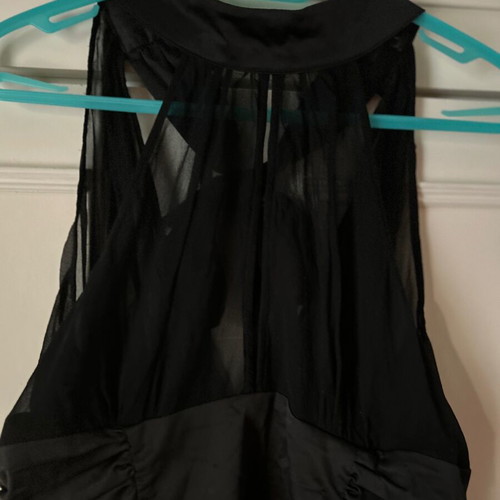 Twentyone L, women's black blouse, made of satin and muslin. The bow at the back.