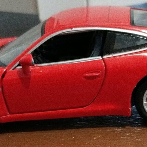 Collectible Porsche Carrera toy car with opening doors like new