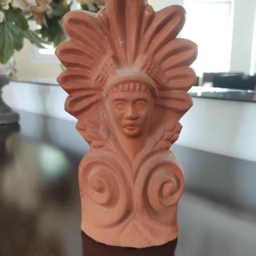 Traditional clay acroterion (anthemion) depicting the form of the God Hermes