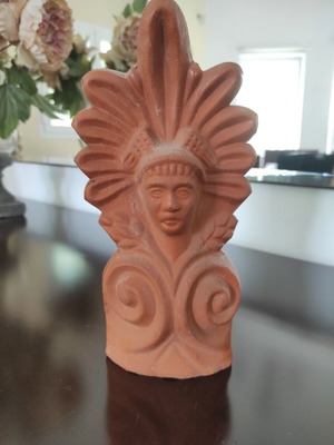 Traditional clay acroterion (anthemion) depicting the form of the God Hermes