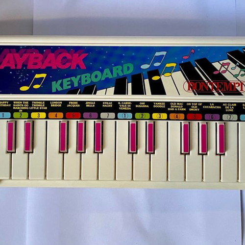 Vintage children's keyboard used with song booklet