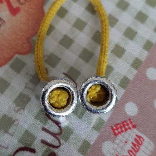 Metal worry beads used with yellow cord