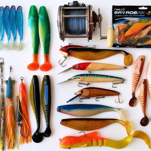 Penn Senator 114H fishing reel with large set of unused artificial lures and soft baits