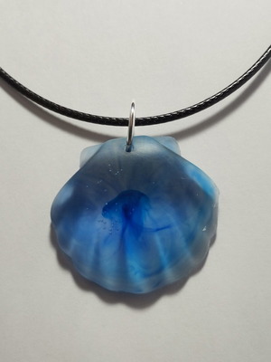 Handmade pendant with blue pigment in shell shape from resin, new
