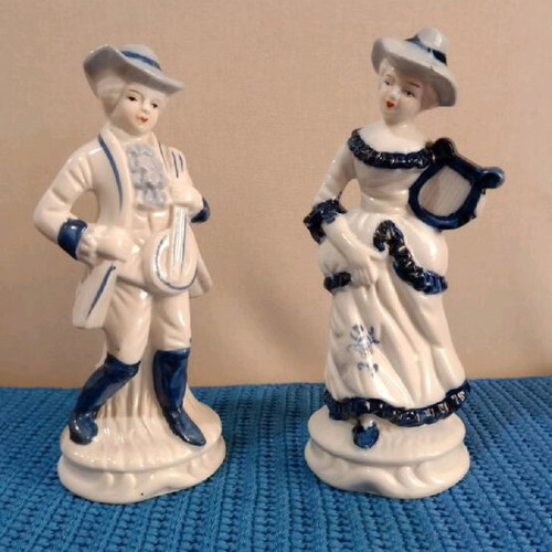 Porcelain figurines couple in traditional costume like new