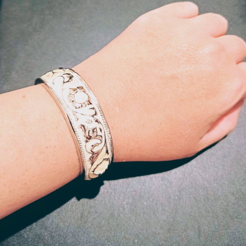 Vintage cuff bracelet with embossed baroque design and white details