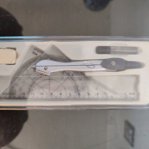 Geometry set like new with compass, protractor, ruler, and pencil