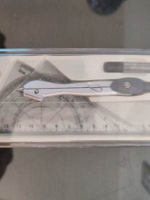 Geometry set like new with compass, protractor, ruler, and pencil