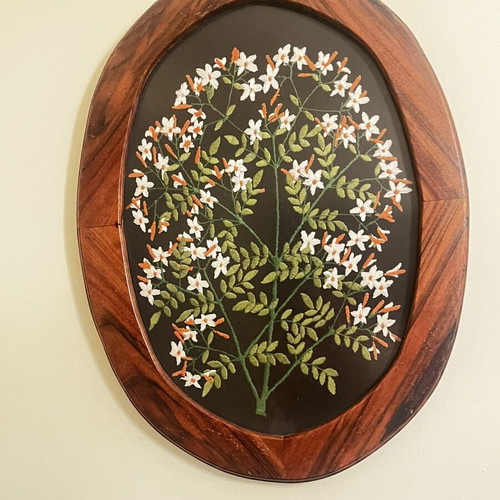 Vintage folk art textile embroidery framed in oval wood