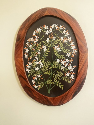 Vintage folk art textile embroidery framed in oval wood