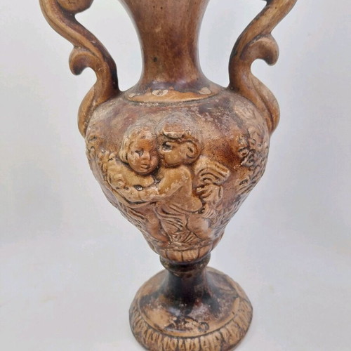 Ceramic amphora vase used, relief with cherubs