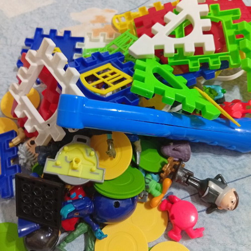 Toy pack with action figures, army men, and construction blocks like new