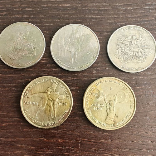 Sports-themed coins used, two 100 and three 500 drachmas