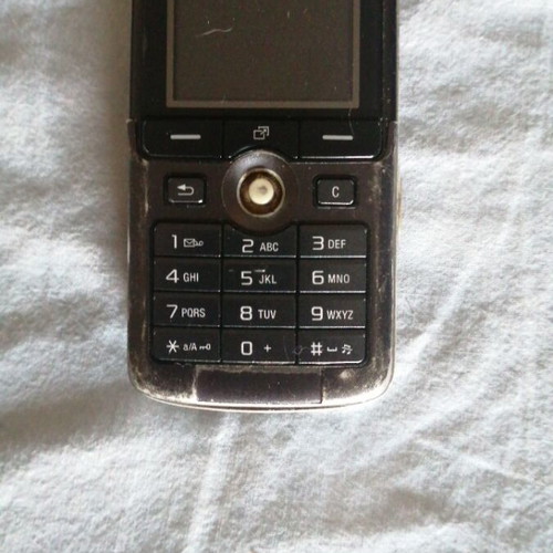 Sony Ericsson mobile phone used, missing back cover