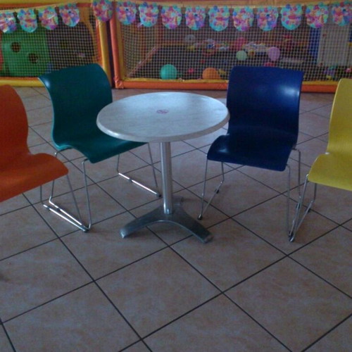 Set of 4 used colorful plastic chairs and round table