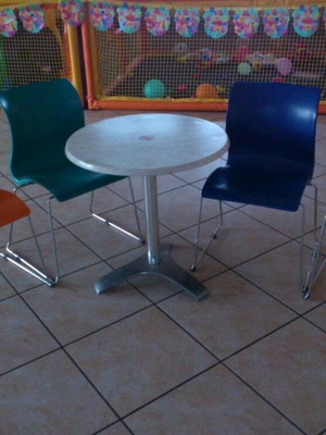 Set of 4 used colorful plastic chairs and round table