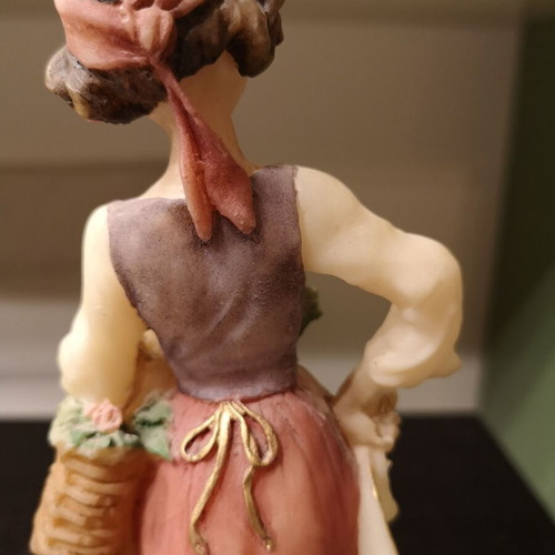 Porcelain figure used with wooden base and girl carrying flowers