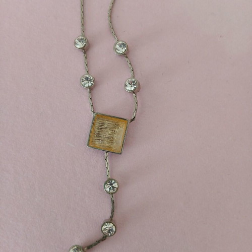 Silver necklace used with white stones and yellowish square